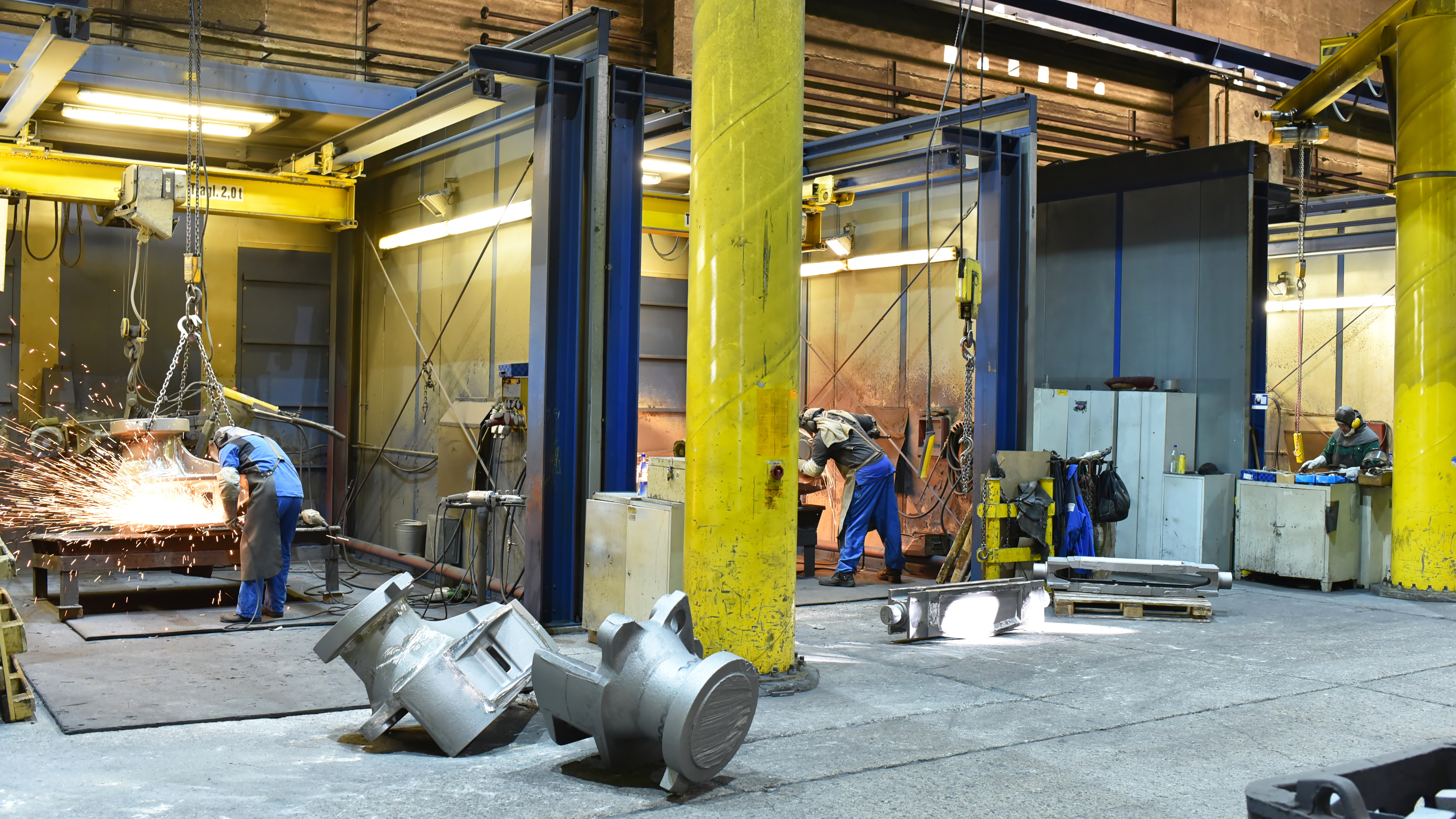 Workers in an industrial metal fabrication plant
