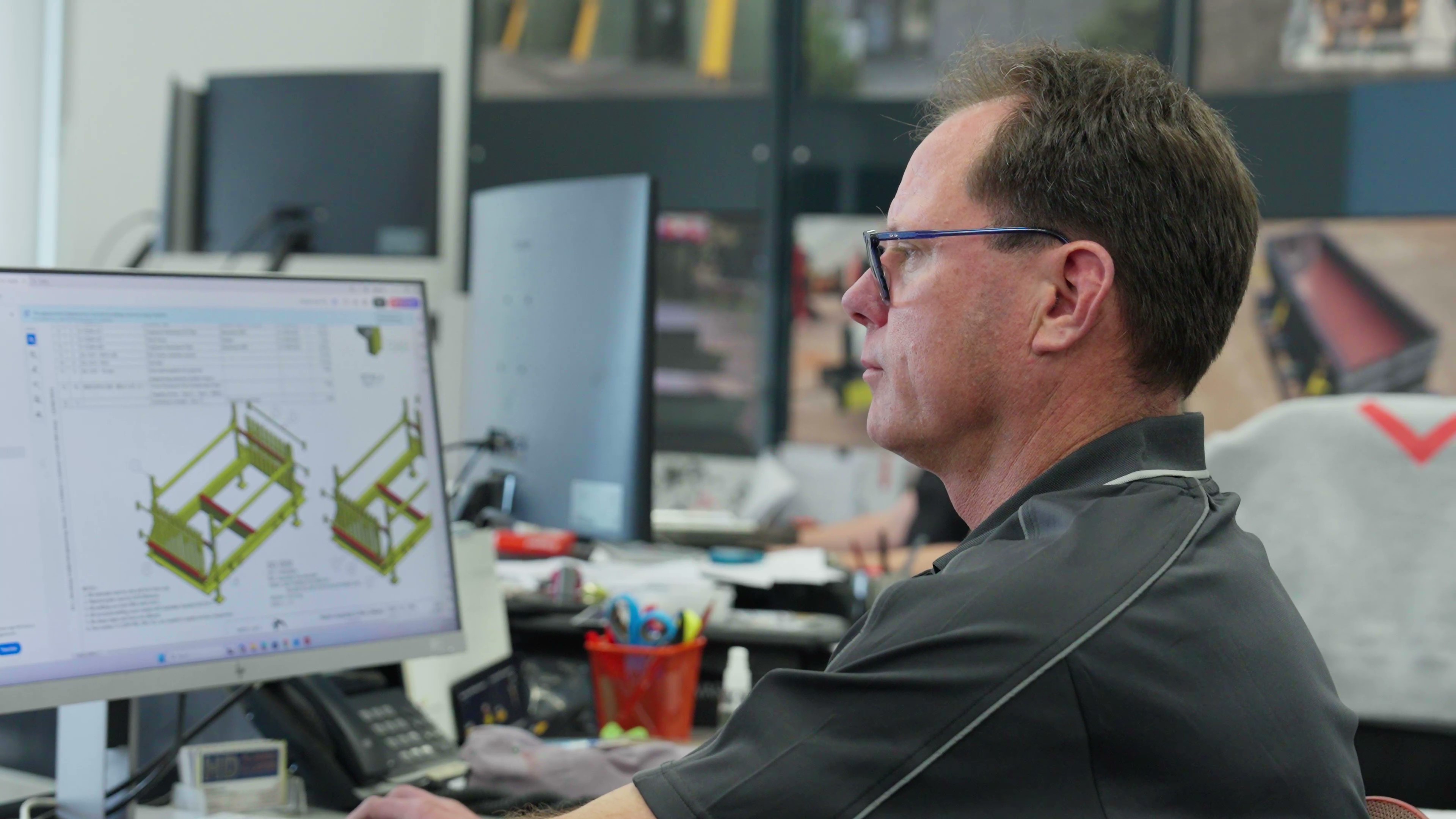 Team member reviewing engineering designs on a computer